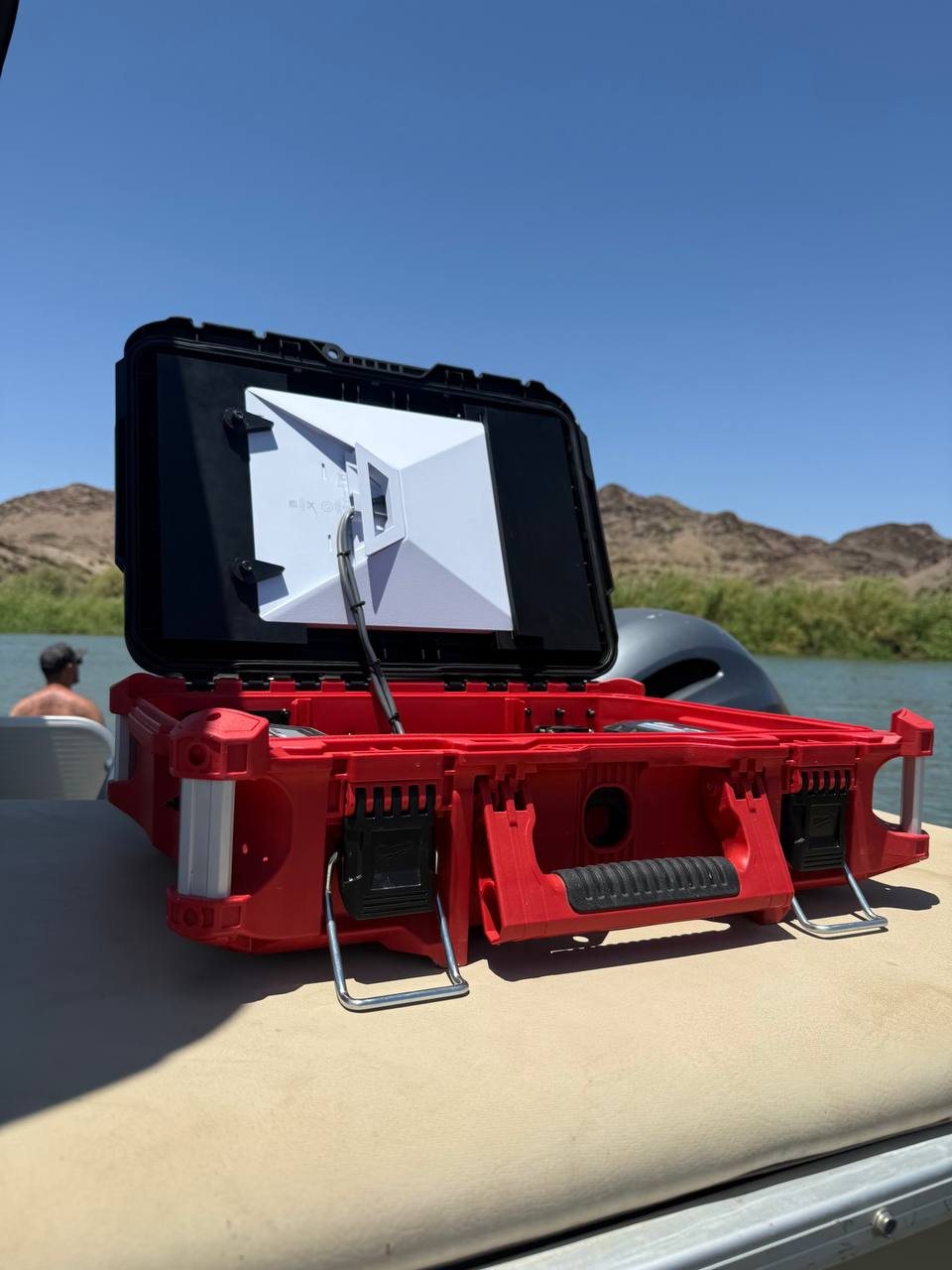 WebStar Box open on a boat at a desert lake